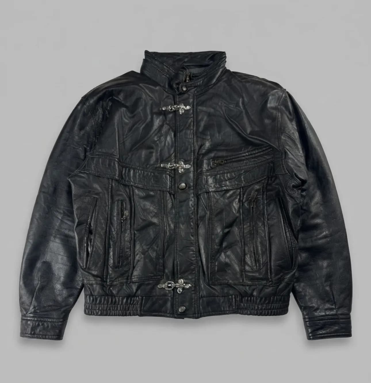 Exclusive vintage leather jacket featuring custom fireman-style clasps.